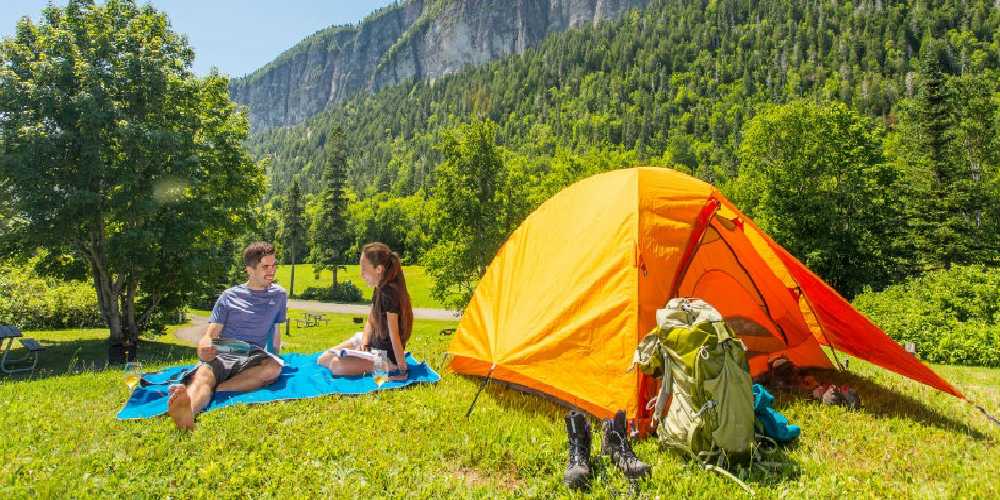 A Couple sitting on the top of lush green field and experience the beauty of france