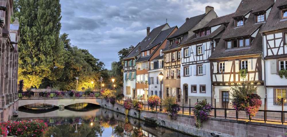 French City Street with a clock tower in the background